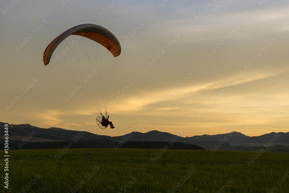 Paraglider flying in the air during colorful sunset. Slovakia Paraglider flying in the air during colorful sunset. Slovakia