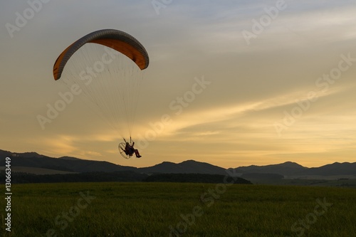 Paraglider flying in the air during colorful sunset. Slovakia