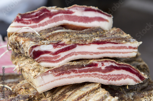 Pieces of smoked bacon on a street stand