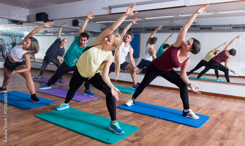men and ladies learning yoga