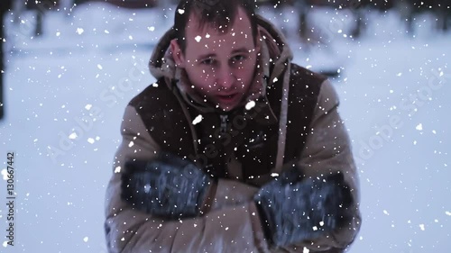 the young man basks in the winter against snow