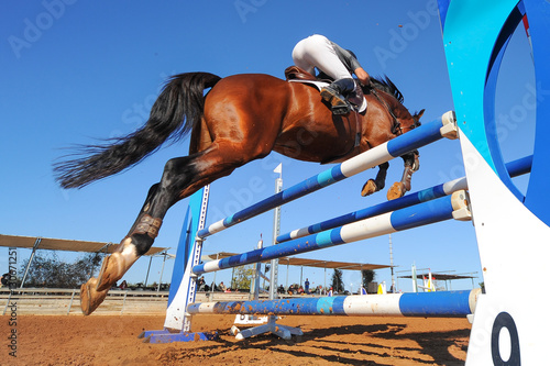 Rider on horse jumping over a hurdle during the equestrian event