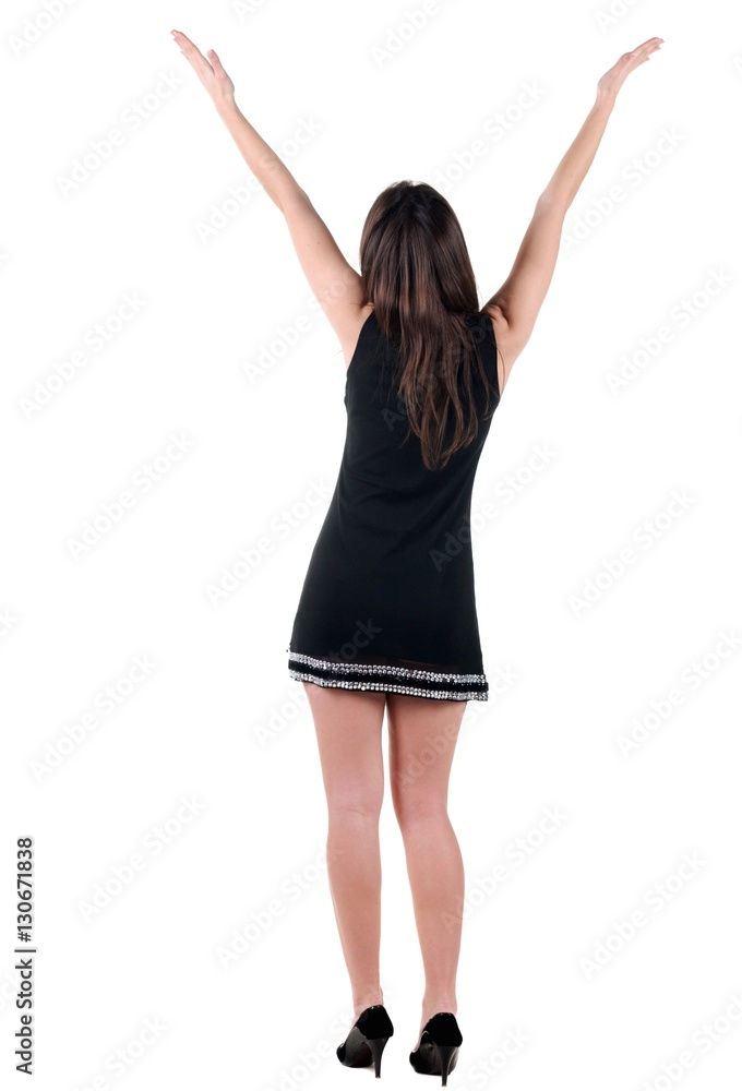 Woman with hands lifted upwards. Rear view. Woman with hands lifted upwards. Rear view.