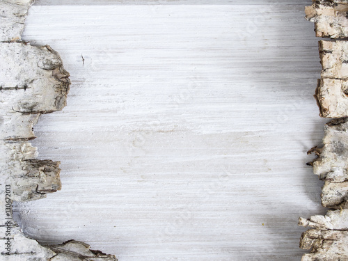 Piece of birch bark on a wooden plank with copy space for text o