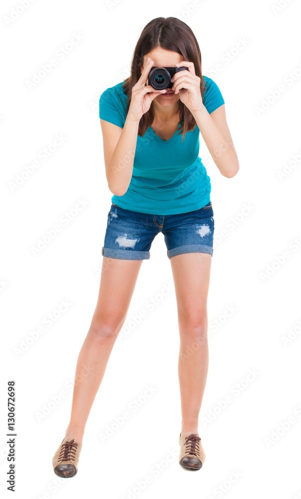 young woman in shorts photographed something compact camera. young woman in shorts photographed something compact camera.