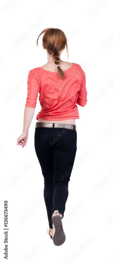 back view of running woman in jeans back view of running woman in jeans