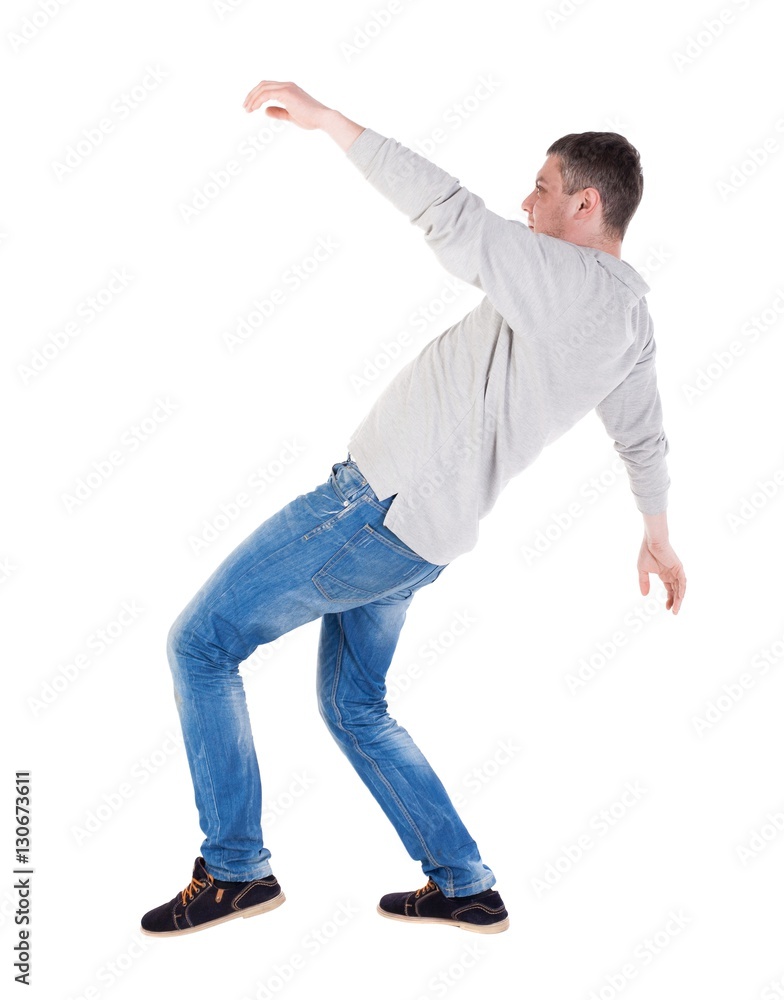 Back view man Balances waving his arms. Rear view people collection. backside view of person. Isolated over white background. slipping man Back view man Balances waving his arms. Rear view people collection. backside view of person. Isolated over white background. slipping man