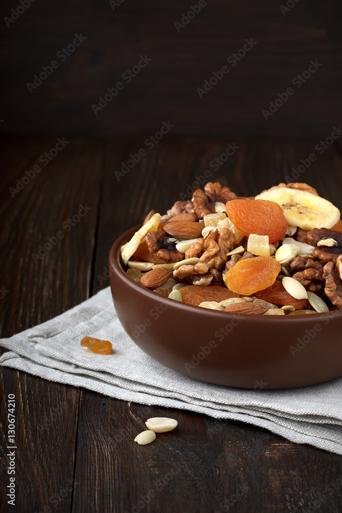 Healthy dried fruits and nuts in bowl on wooden background. Healthy dried fruits and nuts in bowl on wooden background.