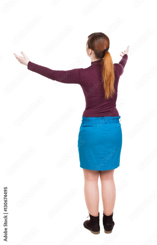 Back view of Beautiful woman in dress looking at wall and Holds Back view of Beautiful woman in dress looking at wall and Holds