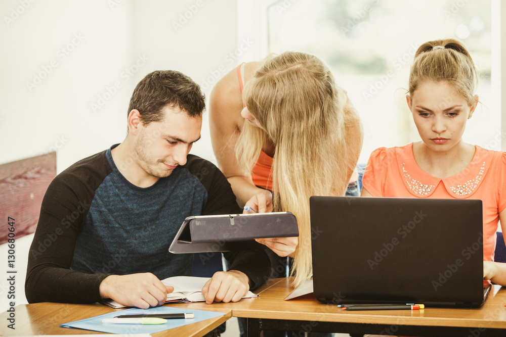 Students and teacher tutor in classroom Students and teacher tutor in classroom