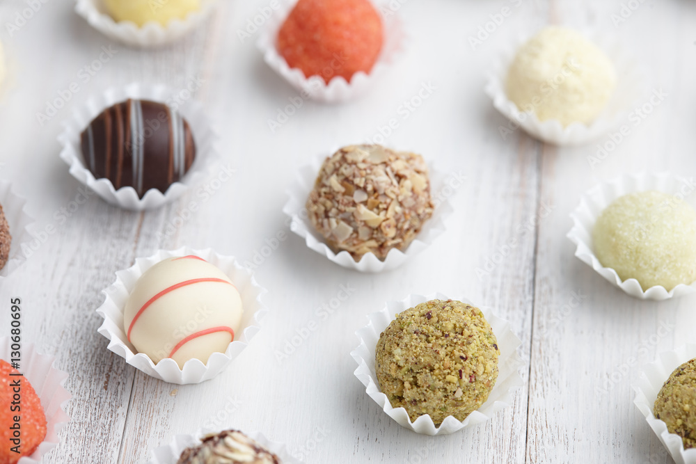 Chocolate truffle candies on white wooden background Chocolate truffle candies on white wooden background