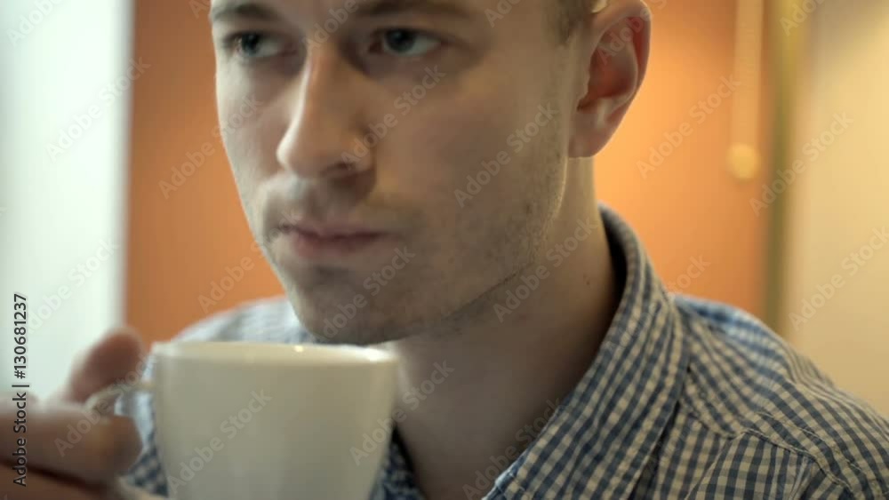 Calm man looks very thoughtful and drinks coffee in the cafe, steadycam shot
Calm man looks very thoughtful and drinks coffee in the cafe, steadycam shot