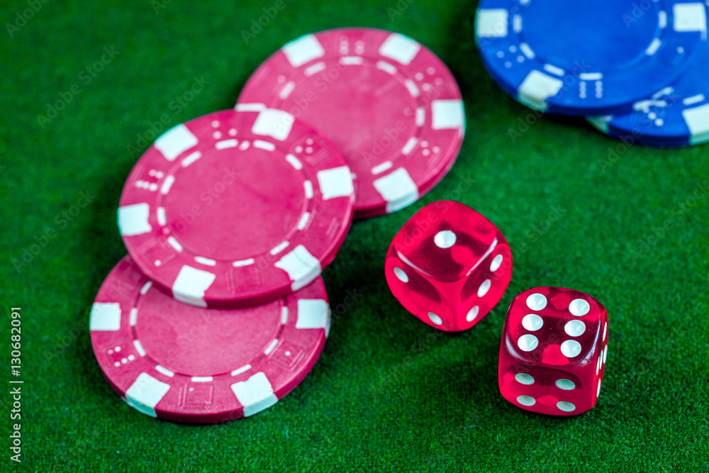 poker chips and dice on green background top view poker chips and dice on green background top view
