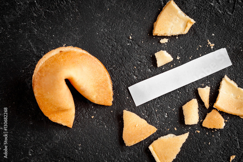 Принти на полотні Chinese fortune cookie with prediction on dark background top view