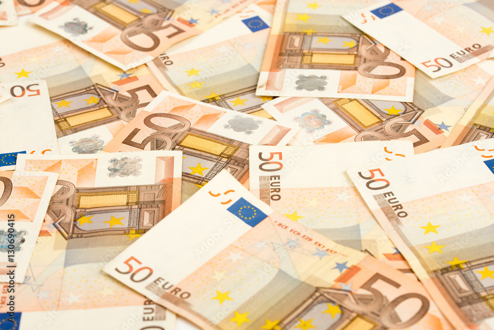 Pile of 50 euro notes - business background. 50 Euro banknotes. Fifty euro money seamless background. Closeup. Pile of 50 euro notes - business background. 50 Euro banknotes. Fifty euro money seamless background. Closeup.