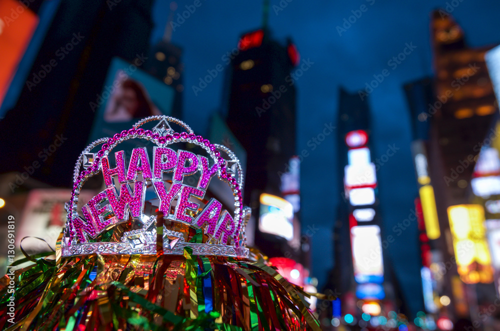 Obraz premium Happy New Year tiara crown celebrating the holiday with colorful decoration in Times Square, New York City