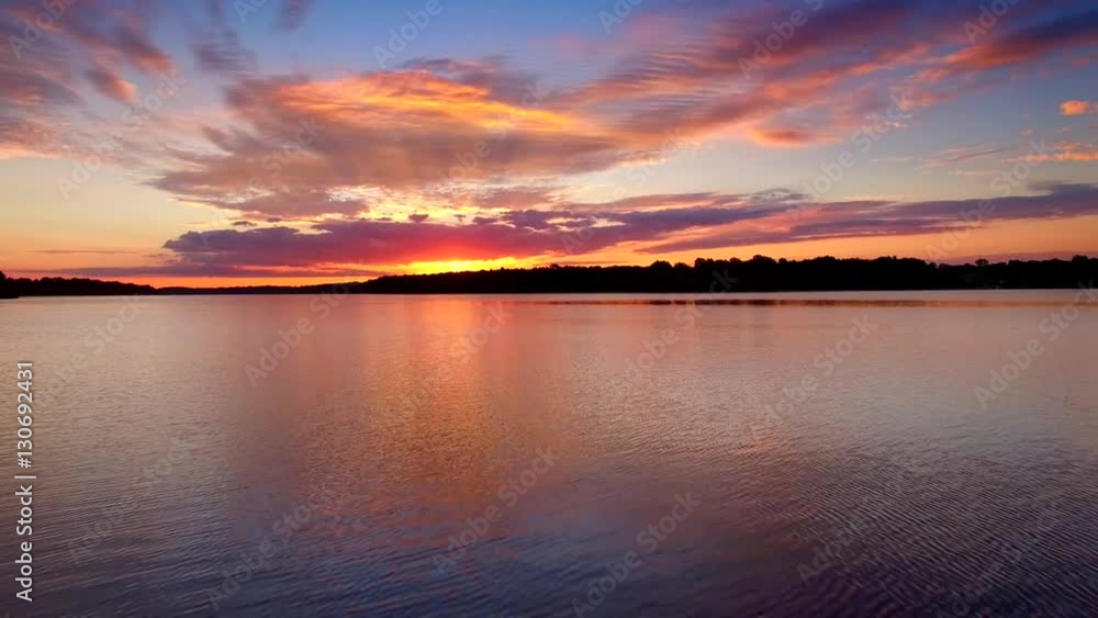Amazing red sunrise reflected in calm waters, moving point of view.
Amazing red sunrise reflected in calm waters, moving point of view.