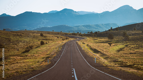 Empty highway leading to mountains photo
