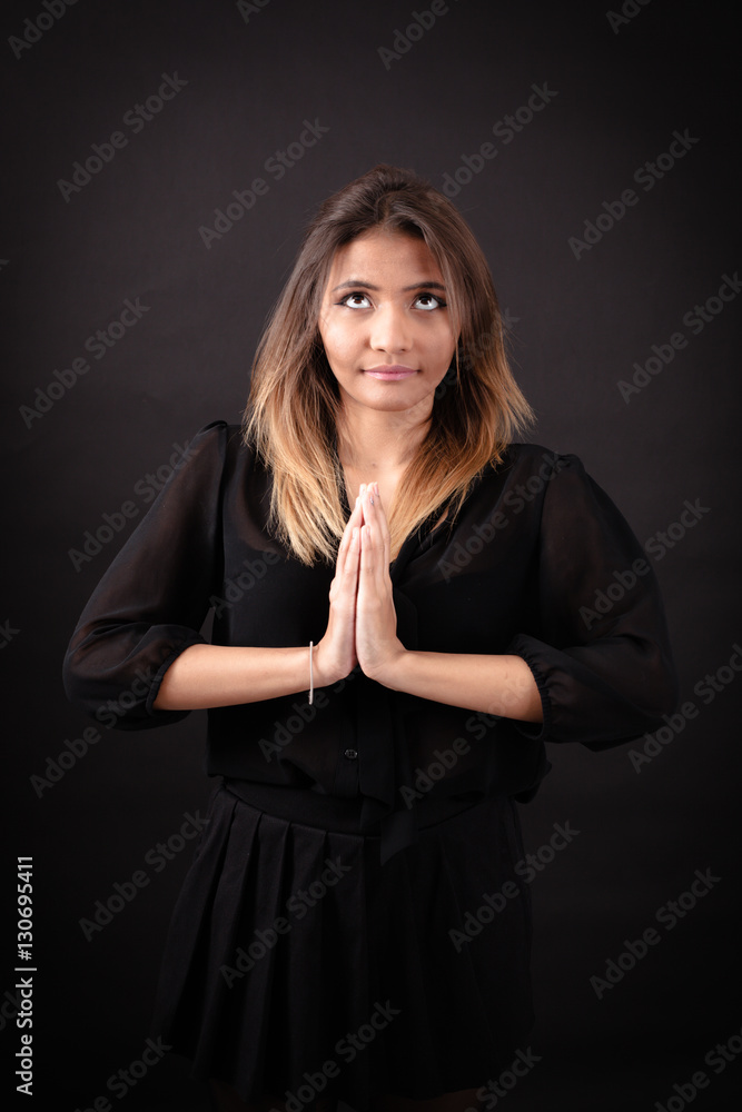 Beautiful woman doing different expressions in different sets of clothes: prayer Beautiful woman doing different expressions in different sets of clothes: prayer
