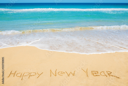Happy New Year message on the beach