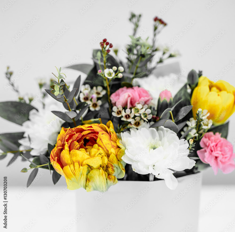 live spring flowers yellow tulips on a white background