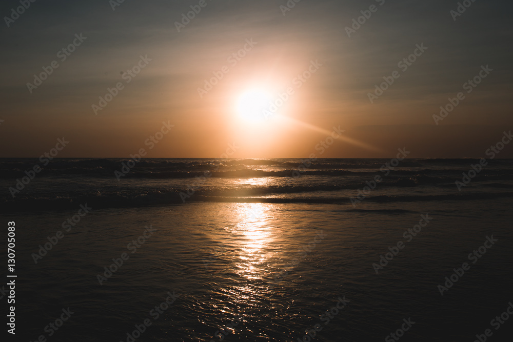 Naklejka premium Sunset on the beach of Indian ocean, Indonesia, Bali