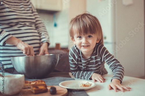 young pregnant mother   with son Toddler, make  dough for baking