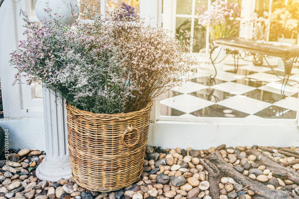 Fototapeta premium Conservatory house chairs plants next to garden with flower bucket.