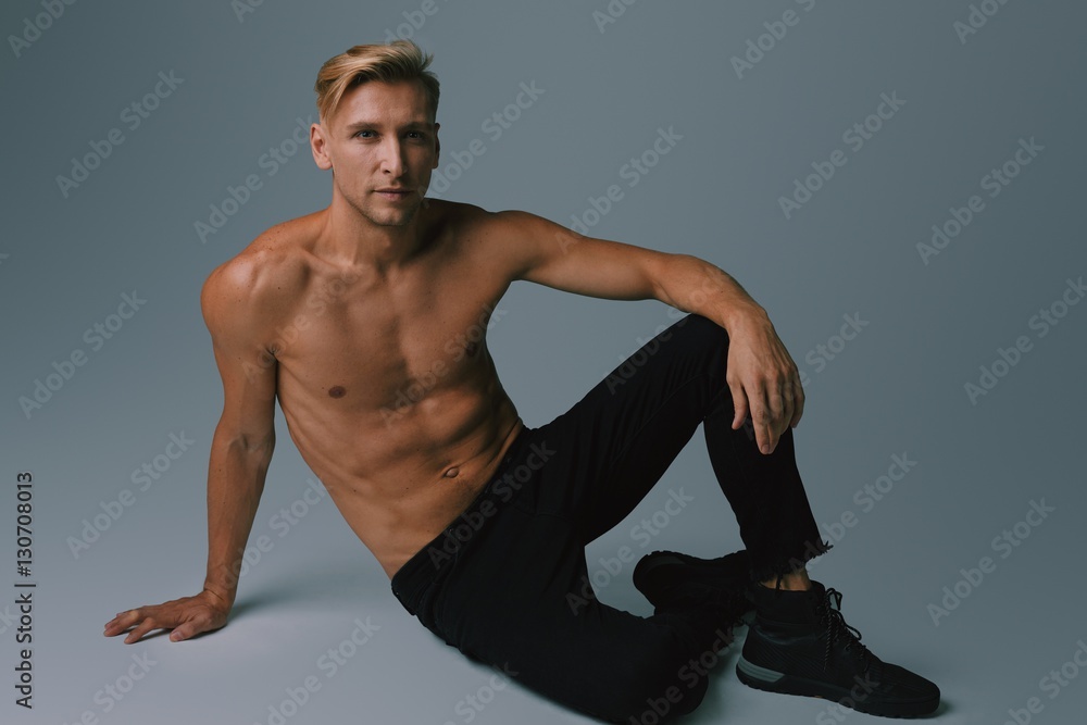 Handsome muscular young man posing at studio Handsome muscular young man posing at studio
