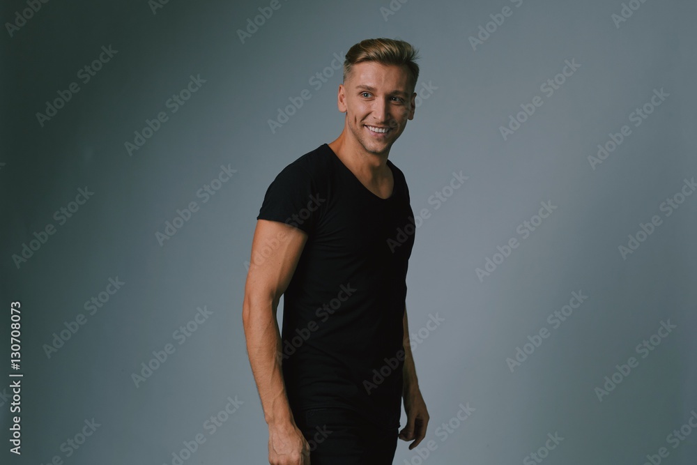 Handsome blond young man posing at studio Handsome blond young man posing at studio