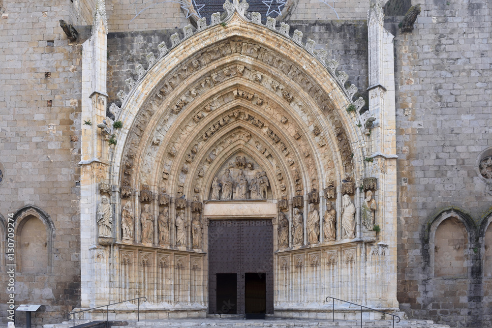 Entrance of the gothic cathedral of Santa Maria in Castello d Empuries, Girona province, Catalonia, Spain