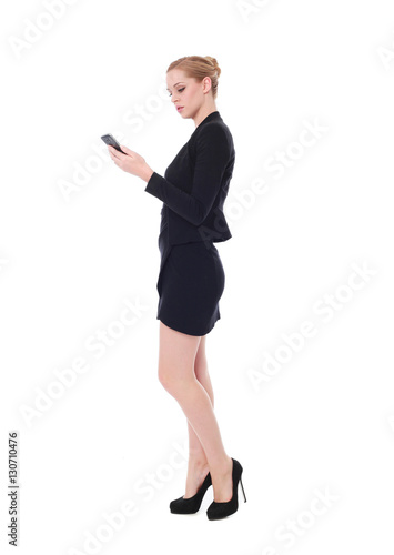 full length portrait of young woman wearing black professional office outfit. standing pose, isolated against white background.