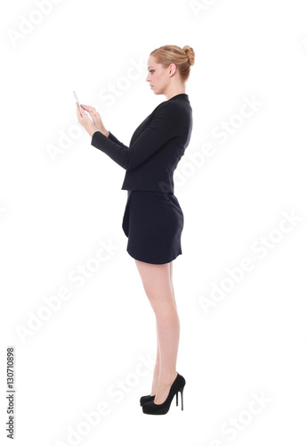 full length portrait of young woman wearing black professional office outfit. standing pose, isolated against white background.