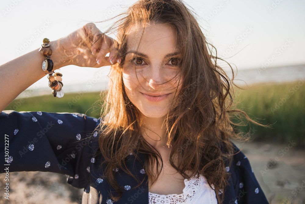 Portrait of a beautiful woman with long hair on the beach. Woman ...