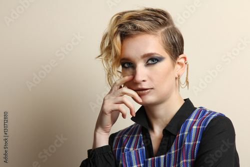 Portrait of a fashion model girl posing in a vest.