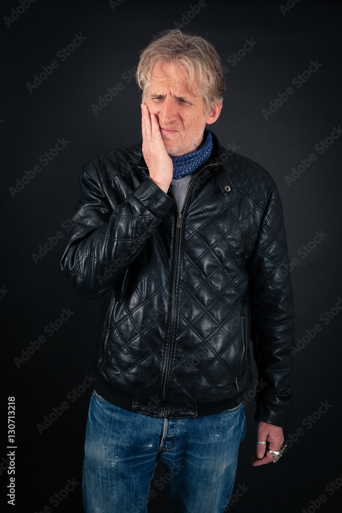 Handsome man doing different expressions in different sets of clothes: toothache Handsome man doing different expressions in different sets of clothes: toothache