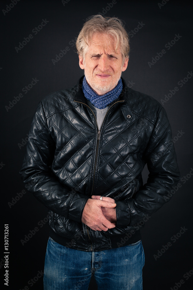 Fototapeta premium Handsome man doing different expressions in different sets of clothes: stomachache