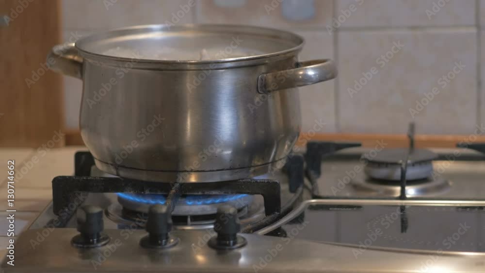 on a gas stove is cooked in the pot soup. the broth is boiling, brewing. beautiful shot with soft focus. on a gas stove is cooked in the pot soup. the broth is boiling, brewing. beautiful shot with soft focus.