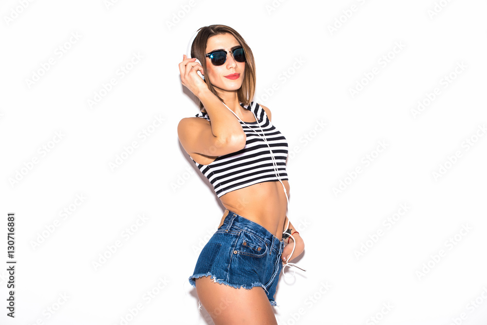 attractive beautiful woman having fun on the white wall,wearing vintage sunglasses,outfit and hat, vacation style