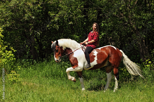 Young pretty country girl on horseback in the forest © horsemen