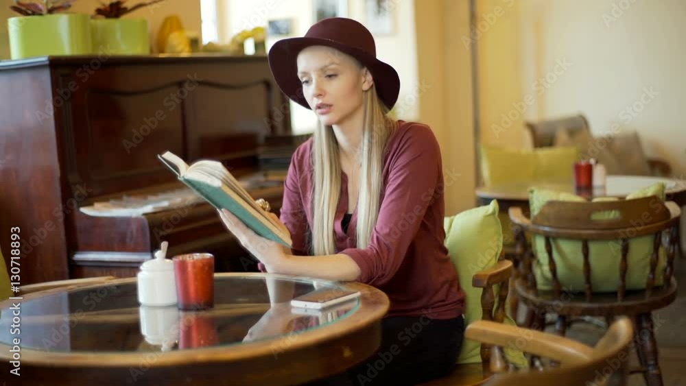 Stylish woman finish reading book and relaxing in a vintage cafe, steadycam shot
Stylish woman finish reading book and relaxing in a vintage cafe, steadycam shot