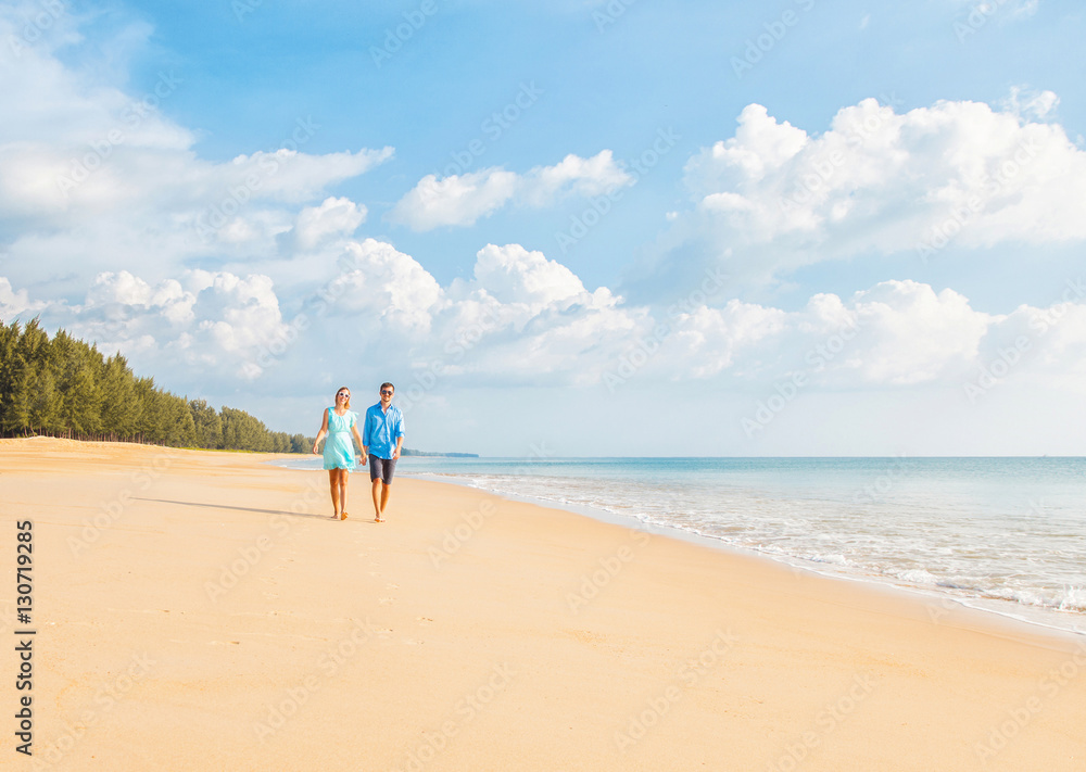 Couple walking on the beautiful beach. Vacation concept