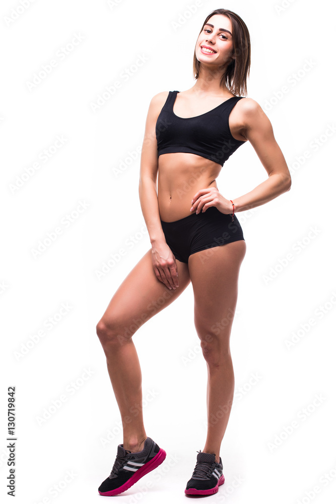 Full length of young beautiful woman in sportswear doing exercises while white background Full length of young beautiful woman in sportswear doing exercises while white background