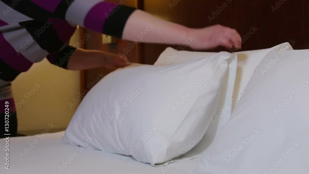 woman runs the linen on the bed woman runs the linen on the bed
