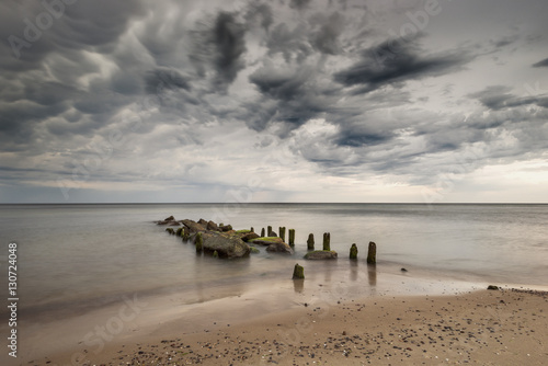 Beautiful sandy beach with a wooden breakwater    long exposure   Baltic Sea   Poland