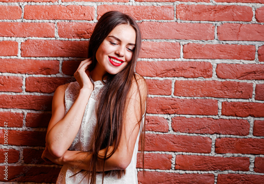 Beautiful modern girl near the brickwall. Youth style. Beautiful modern girl near the brickwall. Youth style.