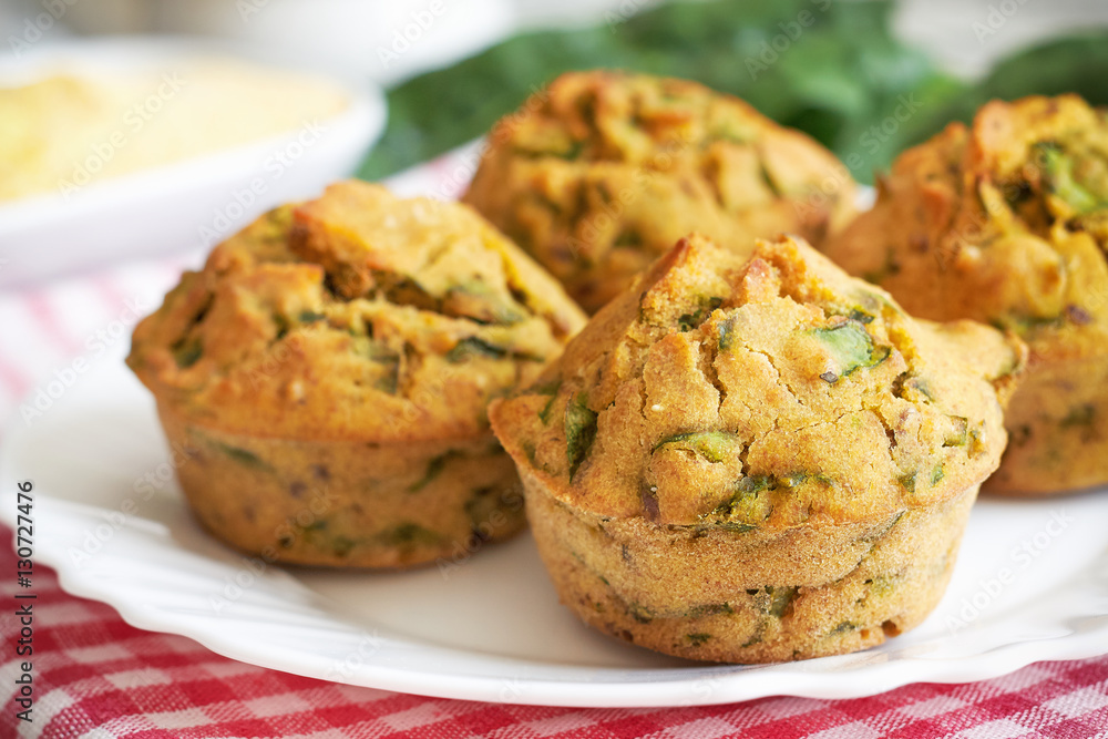 Vegan muffins with spinach and corn flour served on white plate Vegan muffins with spinach and corn flour served on white plate