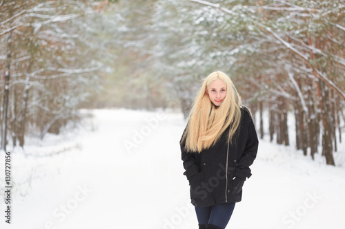 girl in the winter woods on a snowy road