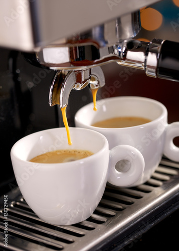 Close up of espresso machine filling two cups