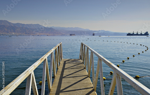Scenic view on the Aqaba gulf (Red Sea) from the central public beach of Eilat - famous resort and recreational city in Israel
